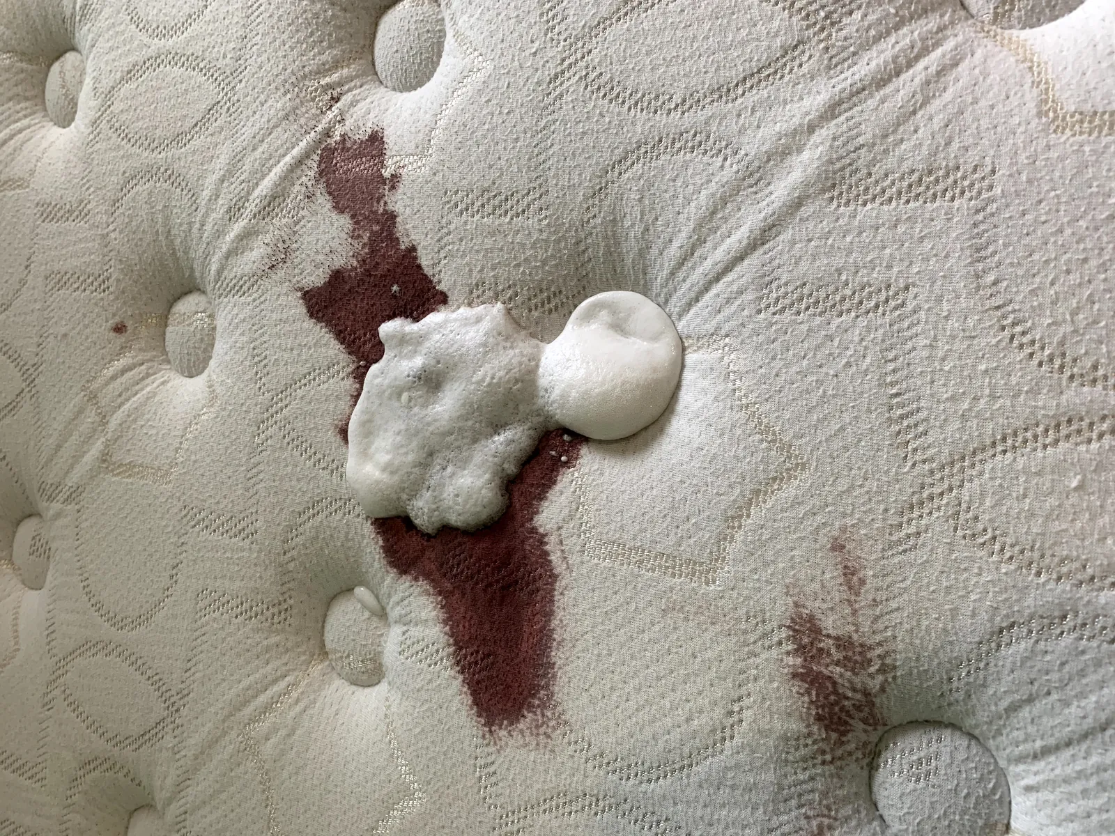 Stain removal treatment on mattress fabric